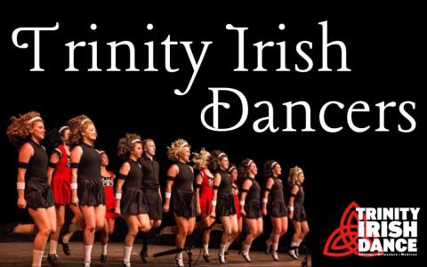 a group of Irish dancers on stage in costume