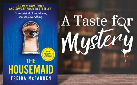 "The Housemaid" book cover on a wood table in a dark library