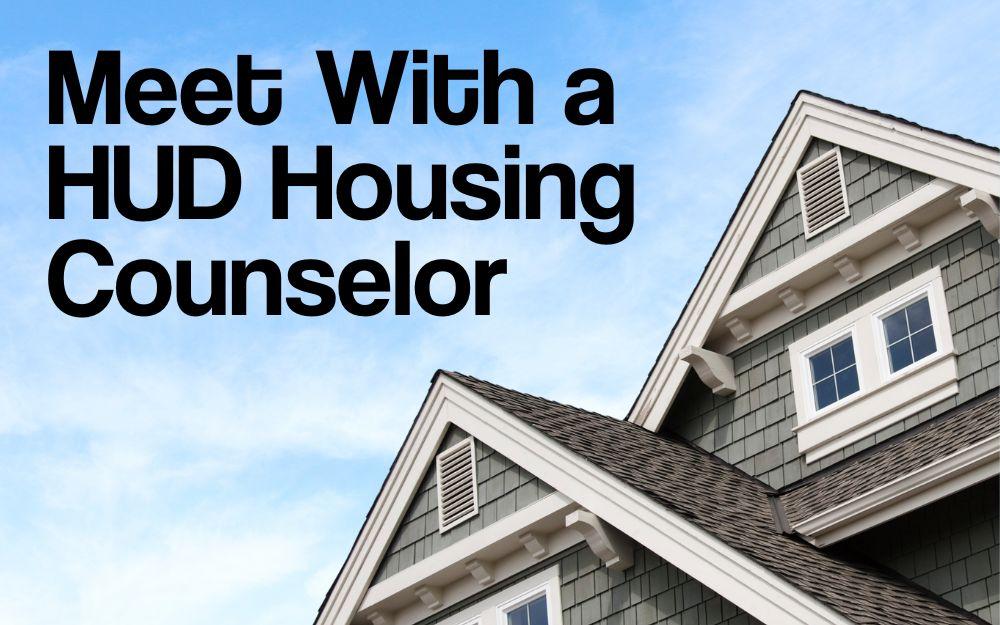 looking up at a house with blue sky and clouds in the background