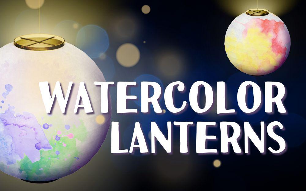 photo of lit up round paper lanterns painted with watercolor